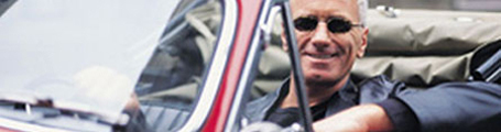 Successful man with sun glasses in red convertible